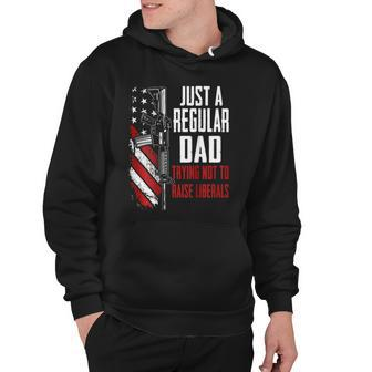 Just A Regular Dad Trying Not To Raise Liberals -- On Back Hoodie | Mazezy