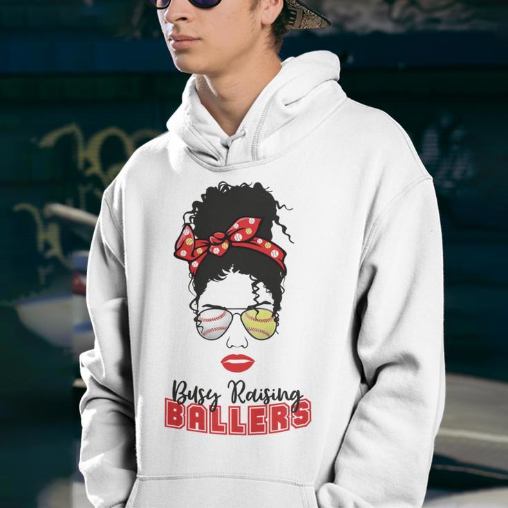 Baseball Busy Raising Ballers Momlife Mom Messy Bun Afro Mom Mothers Day Youth Hoodie