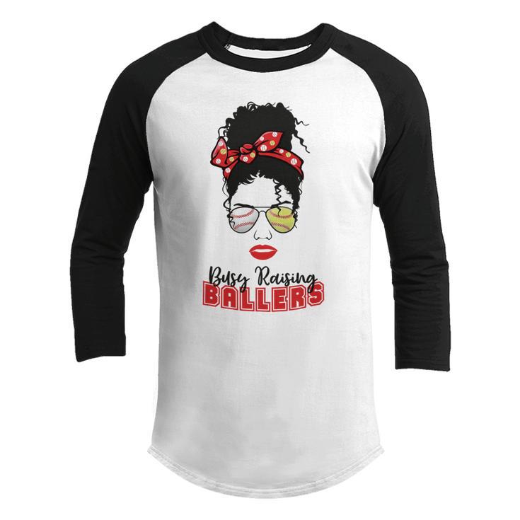 Baseball Busy Raising Ballers Momlife Mom Messy Bun Afro Mom Mothers Day Youth Raglan Shirt