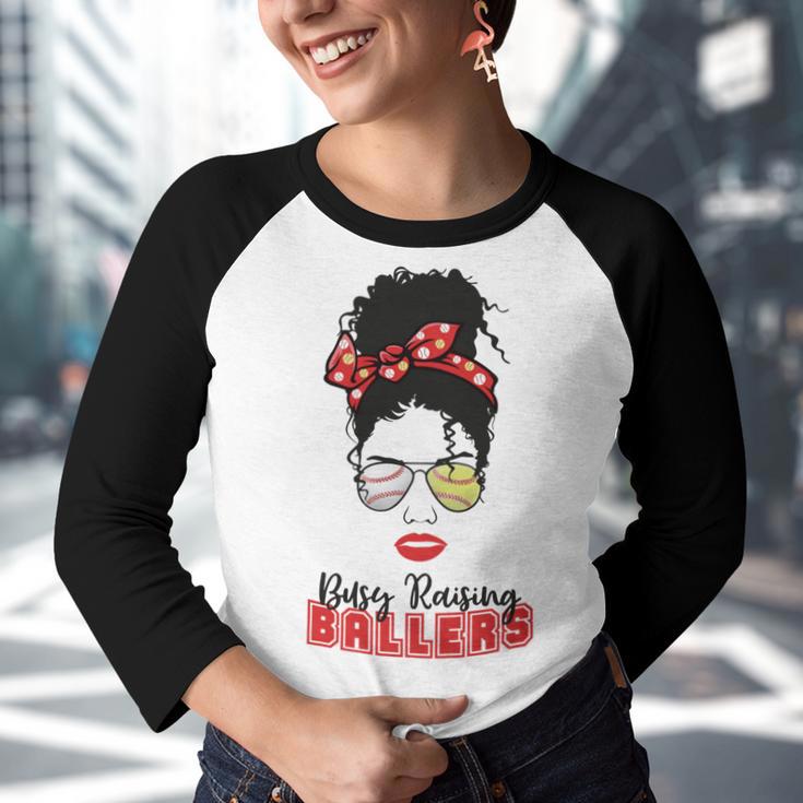 Baseball Busy Raising Ballers Momlife Mom Messy Bun Afro Mom Mothers Day Youth Raglan Shirt